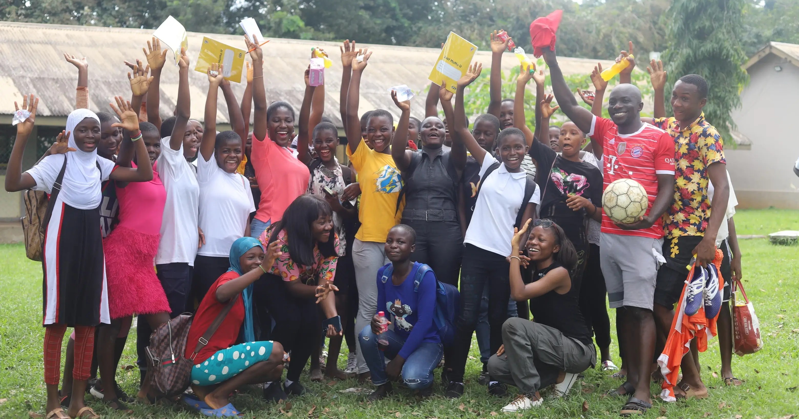 Le Shelter Foundation volunteers distributing school supplies to children in rural Ghana