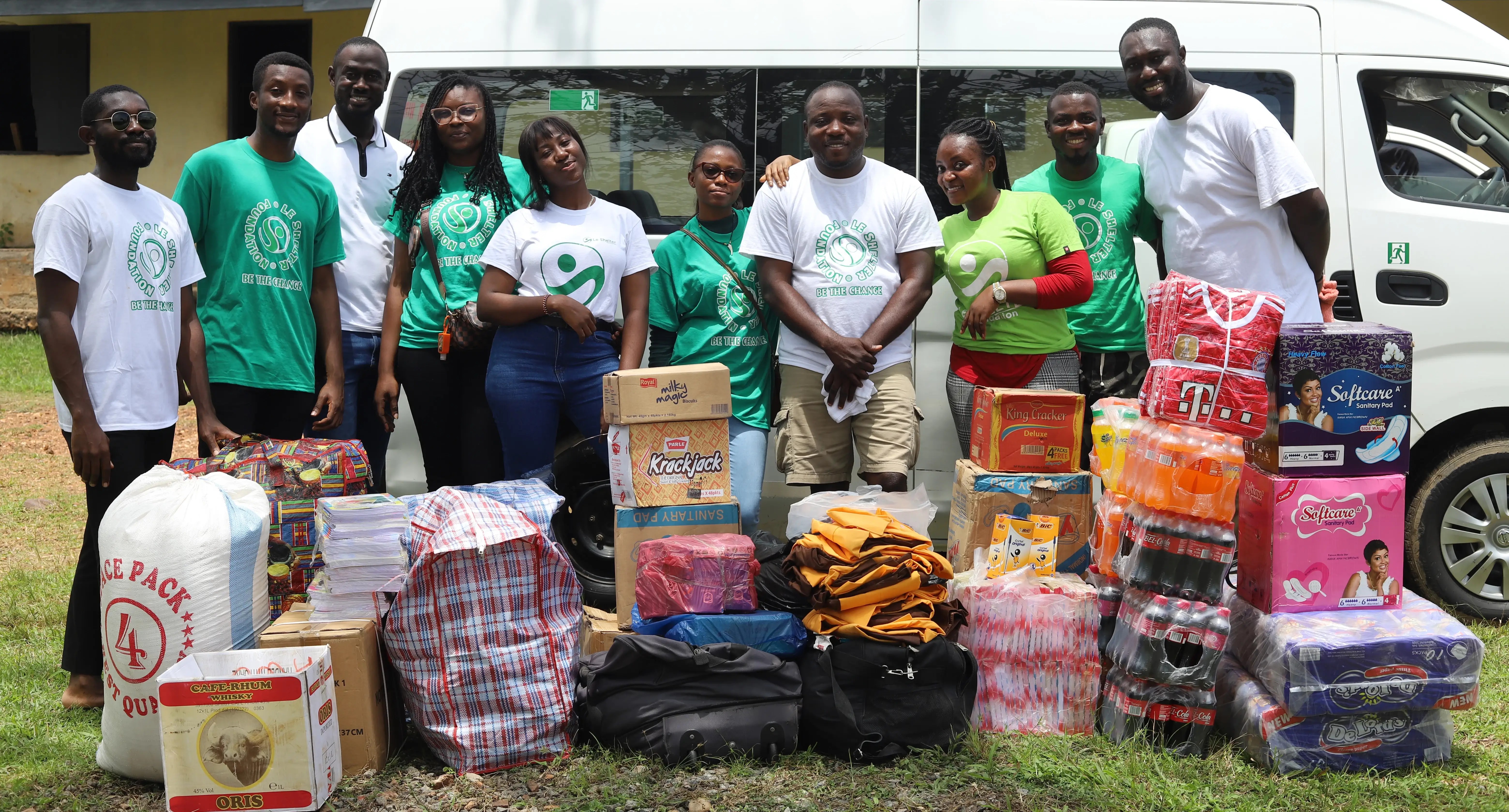 Students receiving educational materials from Le Shelter Foundation
